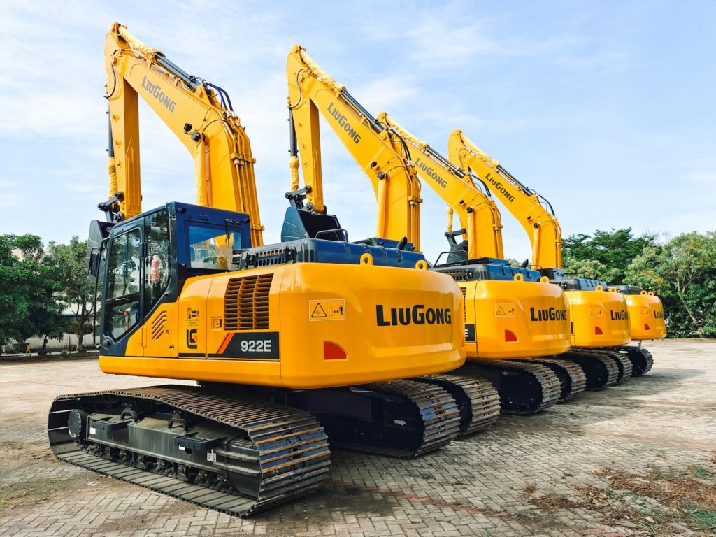 Row of construction machines parked on site