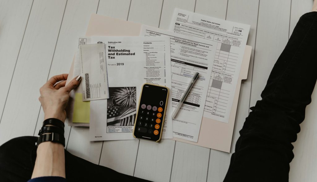 Reviewing finance paperwork with a calculator