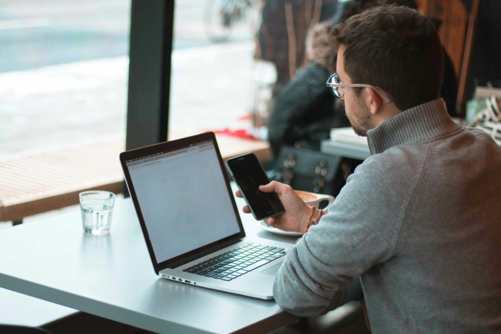 Business owner working on a laptop by the window
